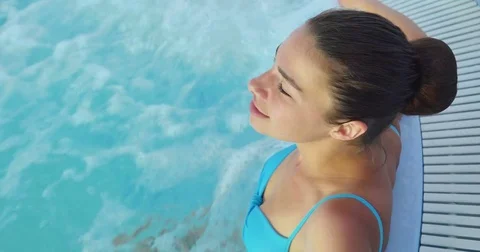 Beautiful young girl (woman) relaxed in a hydromassage bath Stock Footage