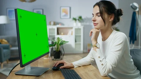 Beautiful Young Girl Works on a Green Mock-up Screen Personal Computer Stock Footage