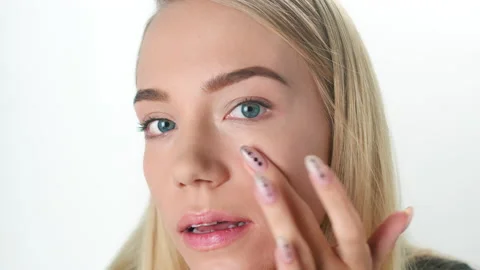 Beautiful young lady applying moisturizing creme, skin care concept Stock Footage 145933221