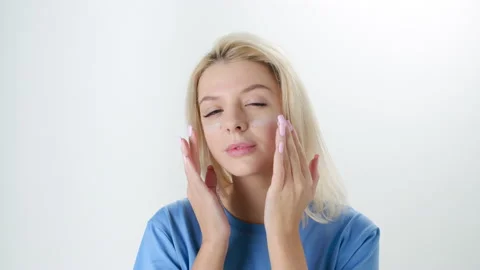 Beautiful young lady applying moisturizing creme, skin care concept Stock Footage 145933483