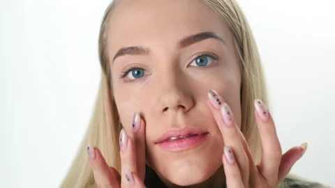 Beautiful young lady applying moisturizing creme, skin care concept Stock Footage 145933600