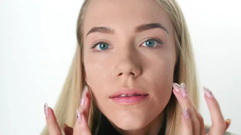 Beautiful young lady applying moisturizing creme, skin care concept. Stock Footage 146089117