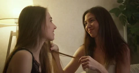 Beautiful young lesbian girlfriends sitt... | Stock Video