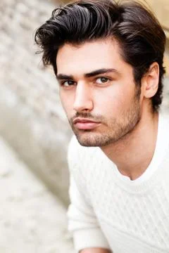 Beautiful young man outdoor. Close portrait, fashion hairstyle. Charming and  Stock Photos