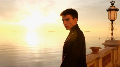 Beautiful young man portrait looking at sunset on the sea Stock Footage 88106437