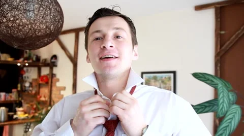 A beautiful young man strikes up a tie and smiles Stock Footage 47862964
