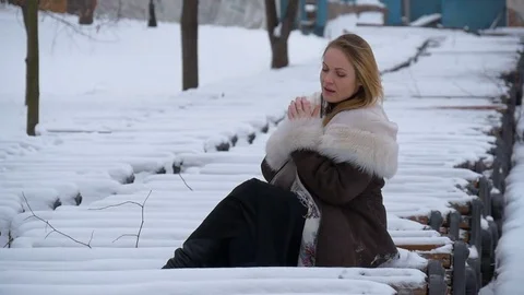 Beautiful young model hand warms. Very cold, winter, snow, wind Video stock 70734955