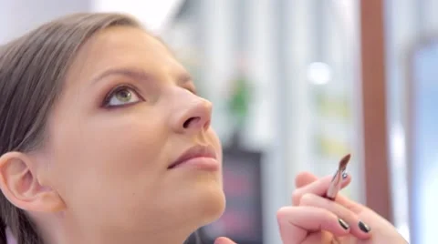 Beautiful young model has make-up applyed close-up Stock Footage 68719913
