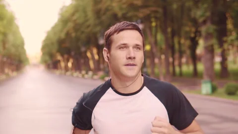 Beautiful young model men training runs in the Park, slow motion Stock-Footage 93778844