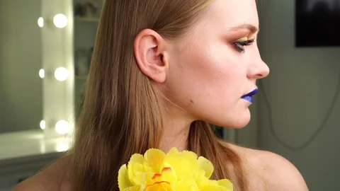 Beautiful young model posing at artistic makeup photoshoot wearing bright Stock Footage 102735786