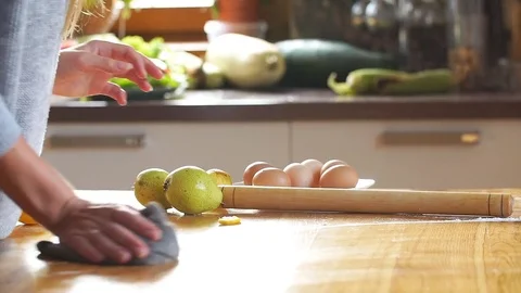 Beautiful young mother doing kitchen work, cleans the table Stock Footage 80192754
