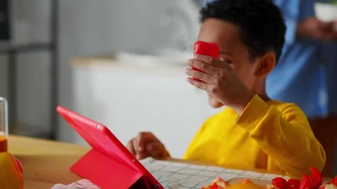 Beautiful young preschool boy sorting vegetables on table slicing pepper Video stock 147271140