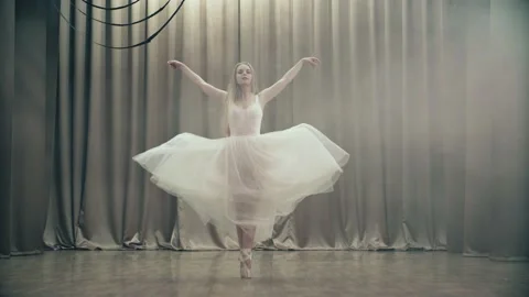 A beautiful young professional dancer performs a beautiful exercise on stage. Stock Footage 155982491