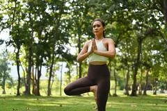 Young millennial blonde woman doing yoga exercise stretching