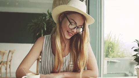 Beautiful young use smartphone in cafe. Stock Footage 74367709
