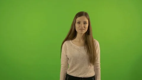 Beautiful young, white model, on a background of a green screen. Shows gesture - Video stock 75382043