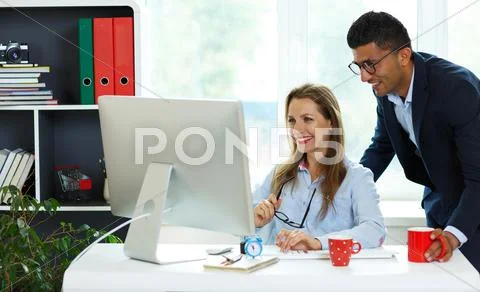 Beautiful young woman and man working from home Stock Photos