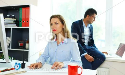 Beautiful young woman and man working from home Stock Photos