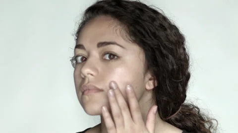 Beautiful Young Woman Applies Facial Cream Stock Footage