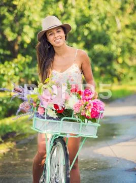 Beautiful young woman on bike Stock Photos