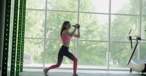 Beautiful young woman does training with kettlebell in gym. Attractive Female Stock-Footage 134371908