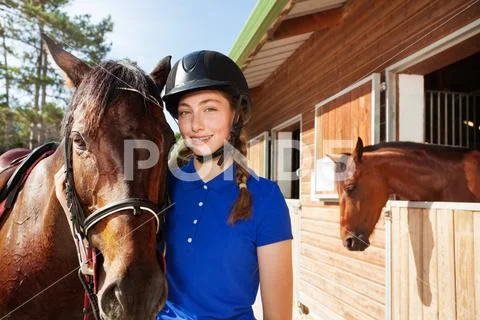 Beautiful young woman with her brown horse Stock Photos