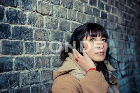 Beautiful young woman listening to music headphones Stock Photos