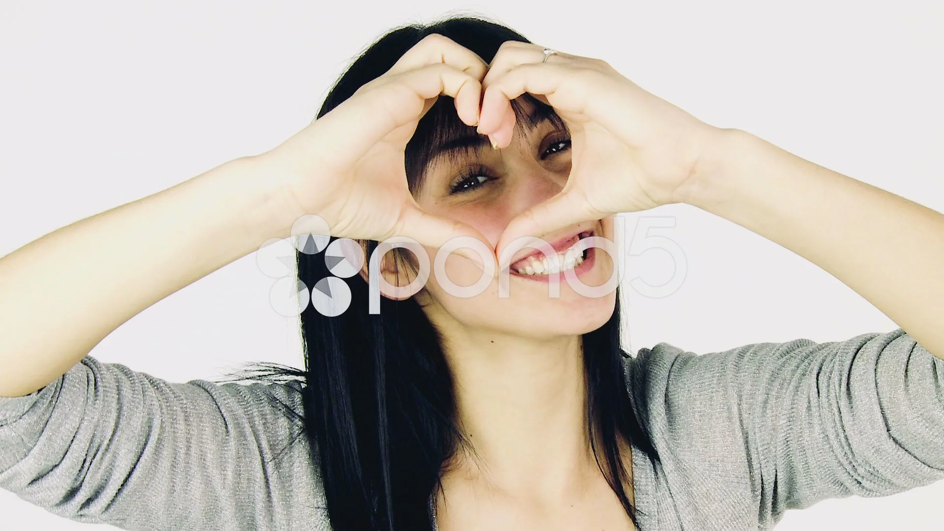 Beautiful young woman making love sign with hands concept