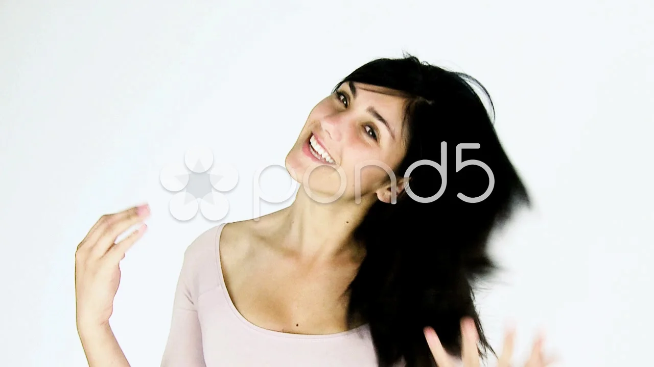 Beautiful young woman playing with black hair in studio