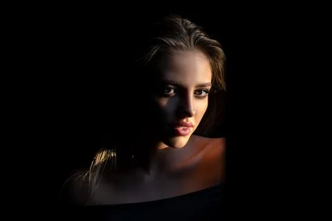 Beautiful young woman portrait on black. Sensual face of elegant female model in Stock Photos