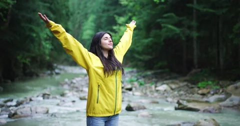Beautiful young woman practicing relaxation tecniques, standing with arms spread Stock-Footage 156980153
