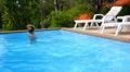 Beautiful Young Woman Relaxing in a Swimming Pool in a Hot Sunny Summer Day. HD Footage
