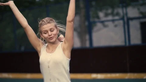Beautiful young woman showing acrobatic stunts. Cheerful girl dances. Stock Footage