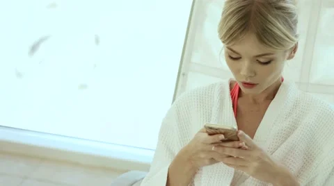 Beautiful young woman with smartphone at spa Stock Footage 59105806
