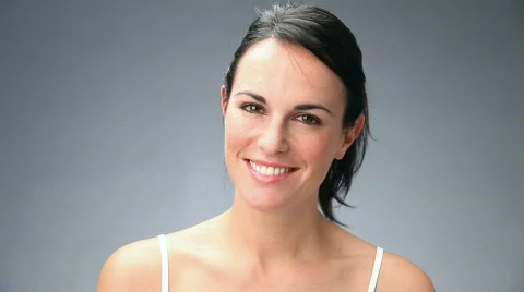 Beautiful young woman smiling and looking at camera Stock Footage