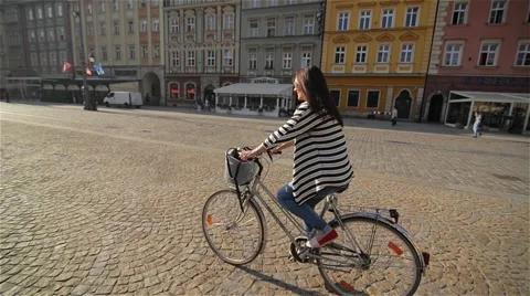 Beautiful young woman smiling while riding her bicycle on a sunny summer day Stock Footage