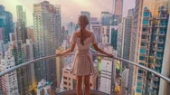 Beautiful Young Woman Standing On Balcony Overlooking City Zoom In Cinemagraph Stock Footage