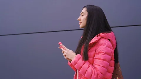 Beautiful young woman thinking while texting a message on phone Stock Footage 125327133