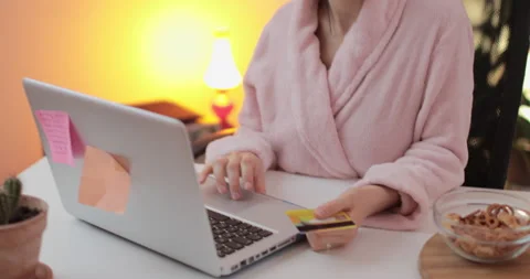 Beautiful young woman using computer and shopping online from the home. Stock Footage 148709987