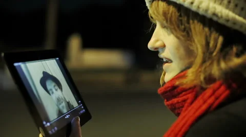 Beautiful young woman using tablet to talk with a friend Stock Footage 34282626