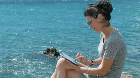Beautiful Young Woman Using Tablet PC On The Beach Stock Footage 65442453