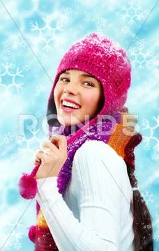 Beautiful young woman in winter clothes looking back and smiling Stock Photos