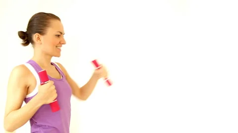Beautiful young woman working out with dumbbells, isolated on white Stock Footage