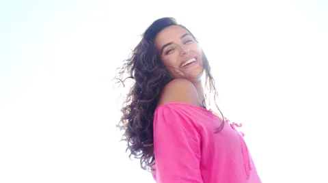 Beautiful young Woman's Face in the Sun Light in Slow Motion. She is Smiling. Stock Footage 67890010