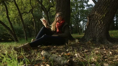 Beautiful young women using tablet in the park. Stock Footage 42407181
