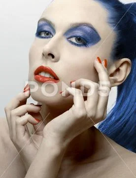 Beautiful_woman_with_blue_eyes_hair_and_eyeshadow_and_red_lipstick_and_polish Stock Photos