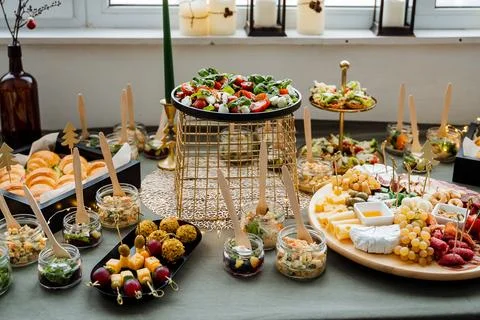 The beautifully arranged dining table features a vibrant array of diverse f.. Fotos de archivo