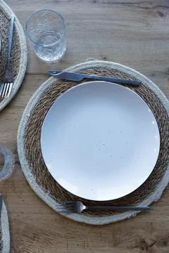 A Beautifully Arranged Dining Table Setting Featuring a Minimalist White Plate Stock Photos