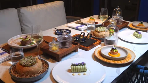 Beautifully arranged fine dining table set for gourmet meal, featuring Stock Footage 281276618