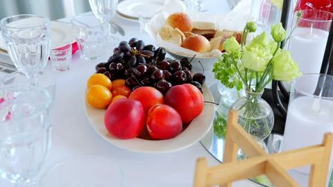 Beautifully arranged table setting featuring a vibrant platter of fresh fruits Stock Photos